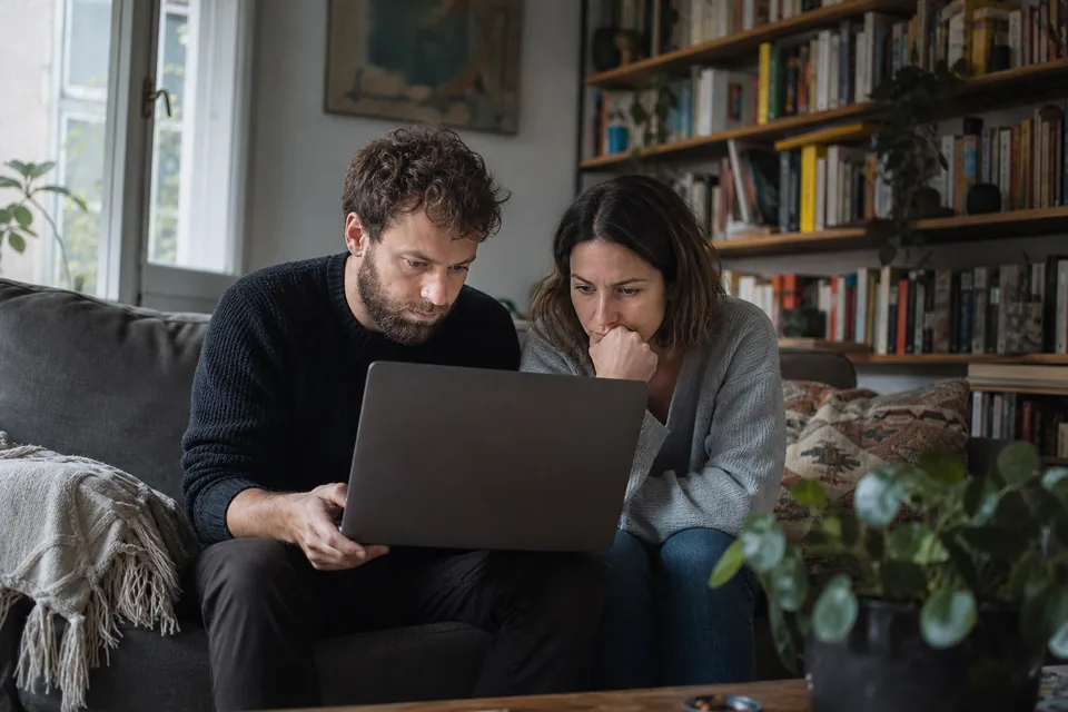 Adult couple reviewing a consent screen on a laptop together