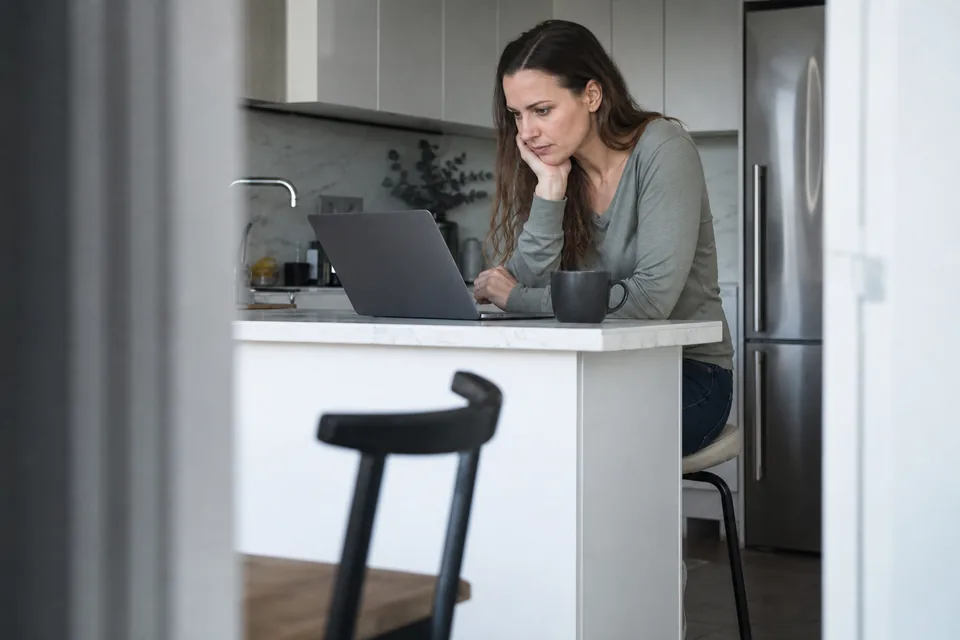 Creator checking her payout summary on a laptop at a desk